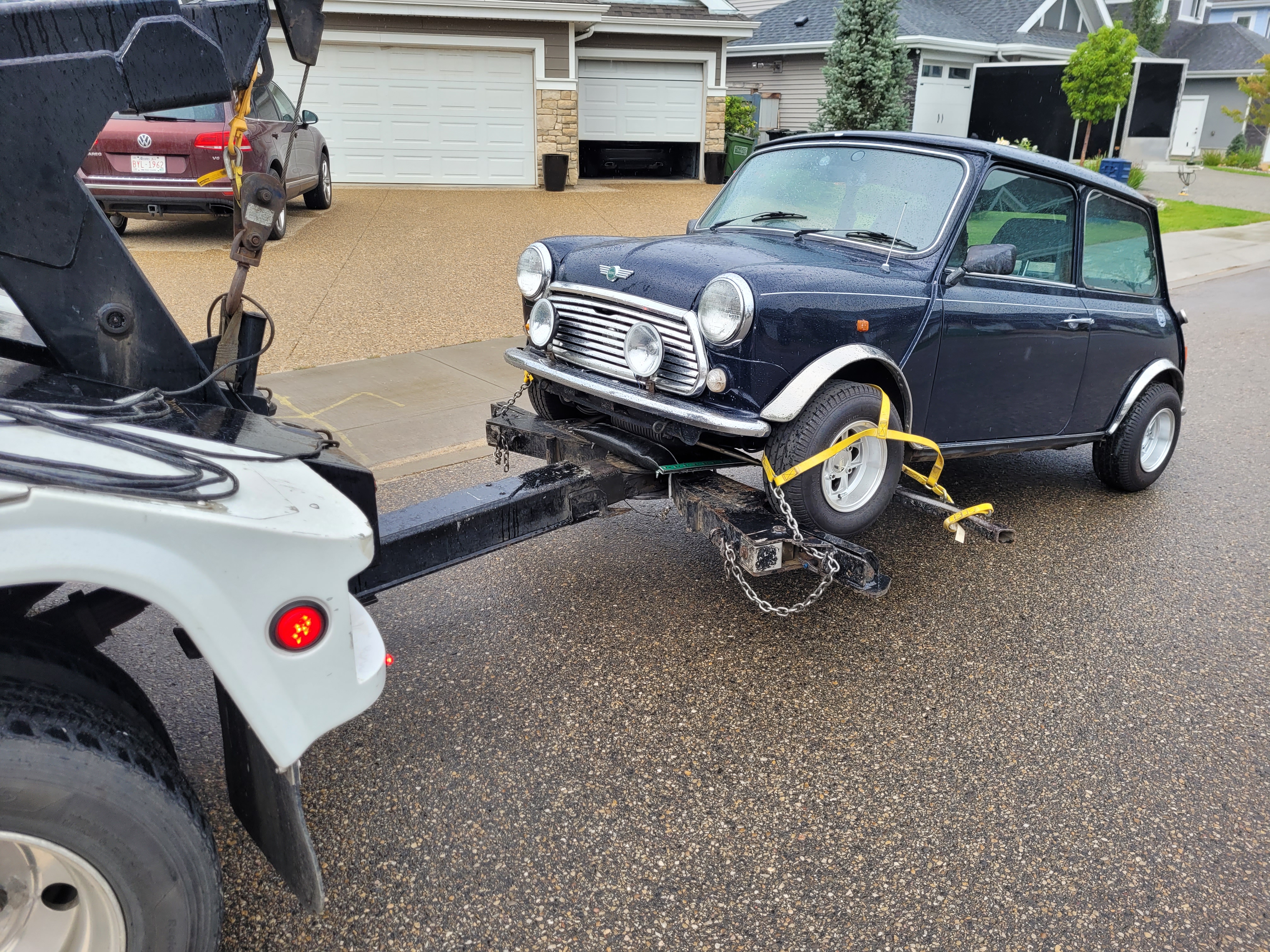 Classic car being towed by a Grid Towing truck